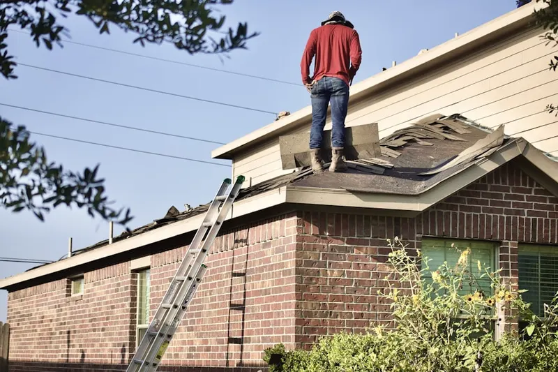 Professional roofer working on a residential roof in Johnsburg